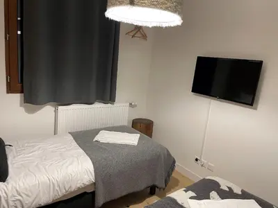 a bedroom with a bed and a flat screen tv at Bel appartement T3 en résidence neuve avec parking et WIFI, proche du village et ski-bus - FR-1-624-168 in Samoëns