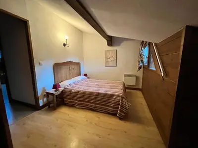 a bedroom with a large bed in a room at Chalet avec terrasse et animaux acceptés, proche centre et ski-bus - FR-1-624-169 in Samoëns