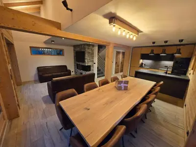 a dining room with a wooden table and chairs at Le chalet des belges - Saint-Gervais in Saint-Gervais-les-Bains