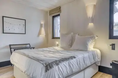a bedroom with a bed with white sheets and pillows at Appartement Orso in Megève