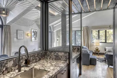a kitchen with a sink and a living room at Appartement Orso in Megève