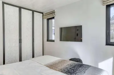 a bedroom with a bed and a tv on a wall at Appartement Orso in Megève