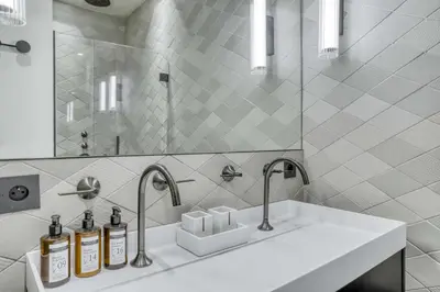 a bathroom with two sinks and two faucets at Appartement Orso in Megève