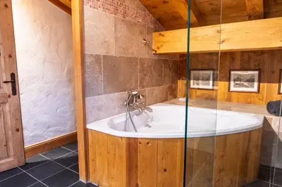 a bathroom with a large tub in a room at Premium 200sqm Chalet in Chamonix Valley ! in Chamonix-Mont-Blanc