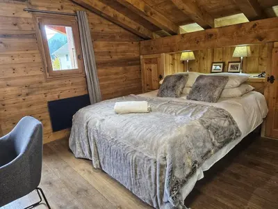 a bedroom with a bed in a wooden cabin at Premium 200sqm Chalet in Chamonix Valley ! in Chamonix-Mont-Blanc