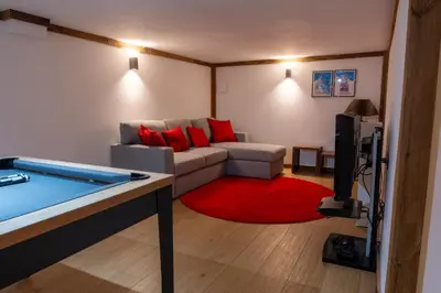 a living room with a couch and a flat screen tv at Premium 200sqm Chalet in Chamonix Valley ! in Chamonix-Mont-Blanc