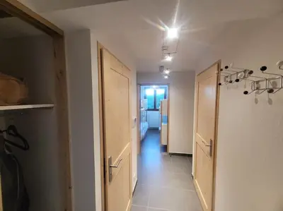 a hallway of a room with two doors and a hallwayngthngthngthngthngth at Zorta - Ground floor apartment with private garden in Samoëns