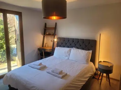a bedroom with a bed with two towels on it at Zorta - Ground floor apartment with private garden in Samoëns