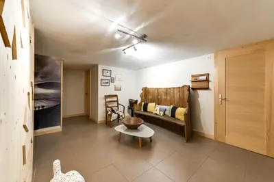 a living room with a couch and a table at Chalet lux et Design Chamonix in Servoz