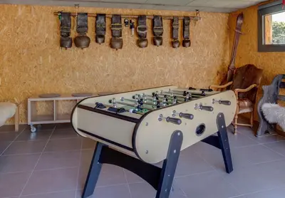 a foosball table in a living room with at Chalet lux et Design Chamonix in Servoz