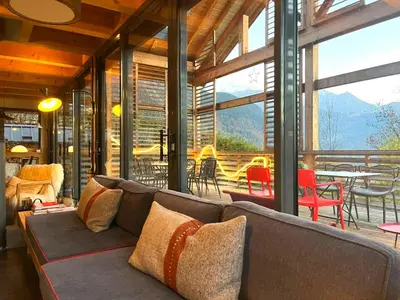 a living room with a couch and a table and chairs at Chalet lux et Design Chamonix in Servoz