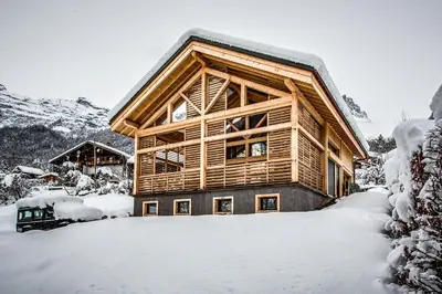a log cabin in the snow with snow covered at Chalet lux et Design Chamonix in Servoz