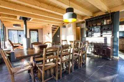 a dining room with a wooden table and chairs at Chalet lux et Design Chamonix in Servoz