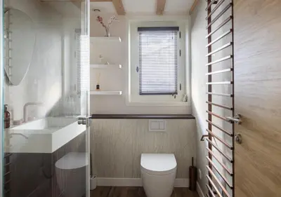 a bathroom with a toilet and a sink and a window at 1 bedroom apartment plus mezzanine in Chamonix-Mont-Blanc