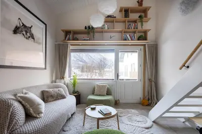 a living room with a couch and a window at 1 bedroom apartment plus mezzanine in Chamonix-Mont-Blanc