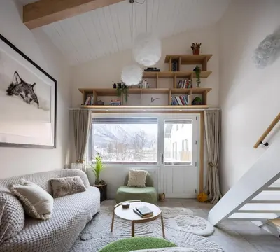 a living room with a couch and a window at 1 bedroom apartment plus mezzanine in Chamonix-Mont-Blanc