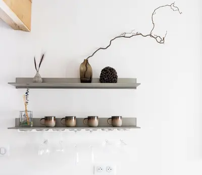 a shelf with wine glasses and a vase on it at 1 bedroom apartment plus mezzanine in Chamonix-Mont-Blanc