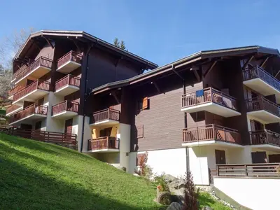 a large apartment building with balconies on a hill at Studio La Piste-5 by Interhome in Saint-Gervais-les-Bains