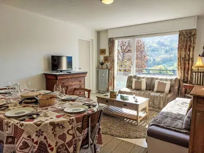 a living room with a couch and a large window at Apartment La côte du Parc-2 by Interhome in Saint-Gervais-les-Bains