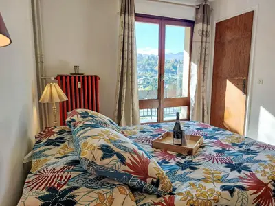 a bedroom with a bed with a bottle of wine on a table at Apartment La côte du Parc-2 by Interhome in Saint-Gervais-les-Bains