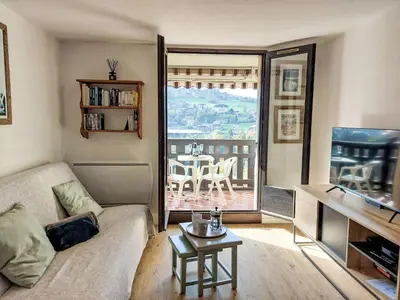 a living room with a couch and a table and a balcony at Studio La Comtesse-11 by Interhome in Saint-Gervais-les-Bains