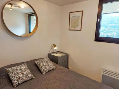 a bedroom with a bed and a mirror at Studio La Comtesse-11 by Interhome in Saint-Gervais-les-Bains
