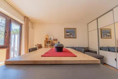 a room with a table with a vase on it at Appartement lumineux à Chamonix avec vue imprenable sur Mont Blanc et parking in Chamonix-Mont-Blanc