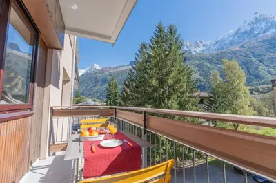 a balcony with a table with a bowl of fruit at Appartement lumineux à Chamonix avec vue imprenable sur Mont Blanc et parking in Chamonix-Mont-Blanc
