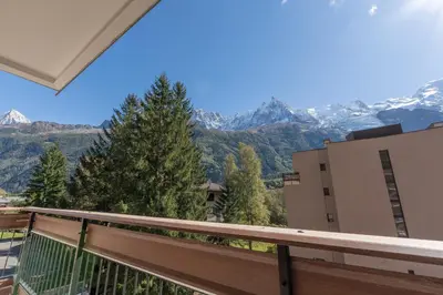 a balcony with a view of mountains at Appartement lumineux à Chamonix avec vue imprenable sur Mont Blanc et parking in Chamonix-Mont-Blanc