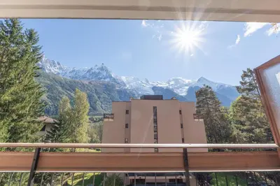 a view of the mountains from the balcony of a house at Appartement lumineux à Chamonix avec vue imprenable sur Mont Blanc et parking in Chamonix-Mont-Blanc