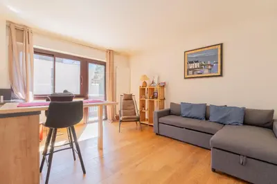 a living room with a couch and a table at Appartement lumineux à Chamonix avec vue imprenable sur Mont Blanc et parking in Chamonix-Mont-Blanc