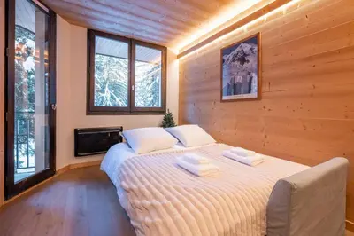 a bedroom with a bed with two towels on it at Chamois Blanc - Quiet Studio close to the town centre - By Cozee Rentals in Chamonix-Mont-Blanc