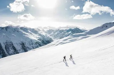 two people skiing down a snow covered mountain at Chamois Blanc - Quiet Studio close to the town centre - By Cozee Rentals in Chamonix-Mont-Blanc