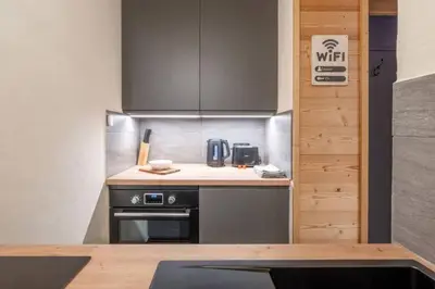 a kitchen with a stove and a counter top at Chamois Blanc - Quiet Studio close to the town centre - By Cozee Rentals in Chamonix-Mont-Blanc