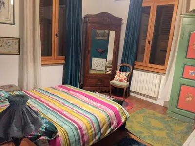 a bedroom with a bed and a chair and a mirror at Chalet station jusqu'à 13 personnes 5 nuits minimum ou 7 en période de vacances scolaires in Samoëns