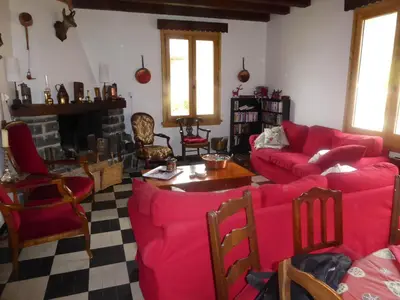 a living room with red furniture and a fireplace at Chalet station jusqu'à 13 personnes 5 nuits minimum ou 7 en période de vacances scolaires in Samoëns