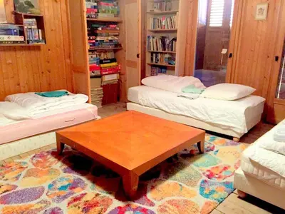a living room with two beds and a coffee table at Chalet station jusqu'à 13 personnes 5 nuits minimum ou 7 en période de vacances scolaires in Samoëns