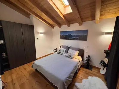 a bedroom with a bed and a skylight at Superbe chalet vallée de Chamonix in Chamonix-Mont-Blanc