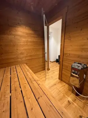 a wooden room with a wooden floor and a room with a door at Superbe chalet vallée de Chamonix in Chamonix-Mont-Blanc