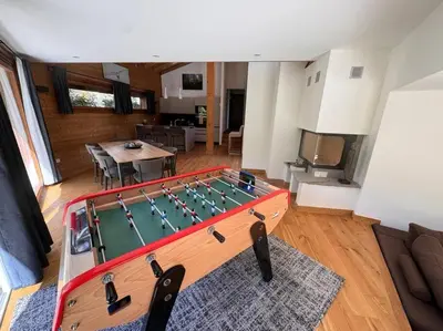 a living room with a large table with at Superbe chalet vallée de Chamonix in Chamonix-Mont-Blanc