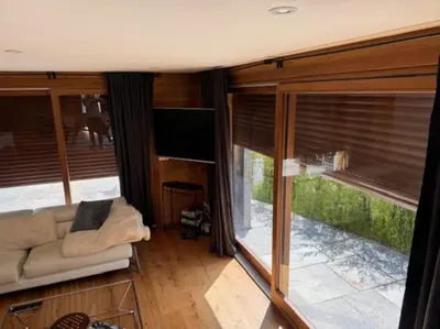 a living room with a couch and a large window at Superbe chalet vallée de Chamonix in Chamonix-Mont-Blanc