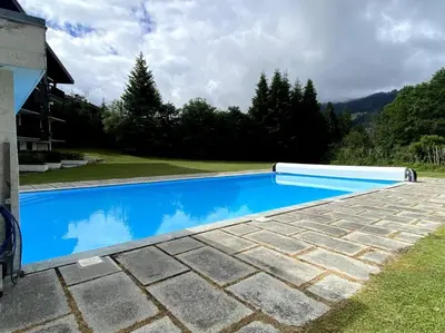 a swimming pool in the backyard of a house at Grand Studio à 300m du pied des pistes, in Megève