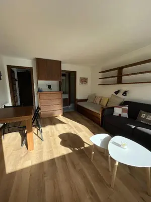 a living room with a couch and a piano at Grand Studio à 300m du pied des pistes, in Megève