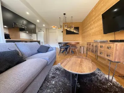 a living room with a couch and a table at Appartement lumineux avec parking à Samoëns, animaux admis - FR-1-624-170 in Samoëns