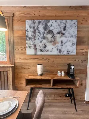 a room with a wooden wall with a table at Studio Cosy cœur de Megève Le Soleil Levant in Megève