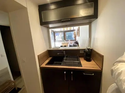 a small kitchen with a sink and a window at Appt Cosy au centre Chamonix in Chamonix-Mont-Blanc