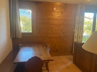 a room with a wooden wall with a bench and a window at Appartement Samoëns in Samoëns