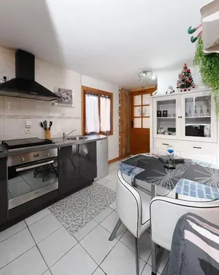 a kitchen with a table and a counter top at La Charlotte in Sallanches