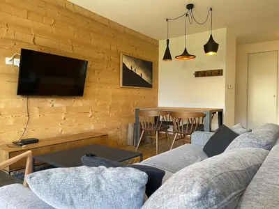 a living room with a couch and a tv at Appartement lumineux avec terrasse et parking à Samoëns - FR-1-624-171 in Samoëns