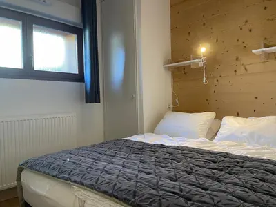 a bedroom with a bed and a window at Appartement lumineux avec terrasse et parking à Samoëns - FR-1-624-171 in Samoëns